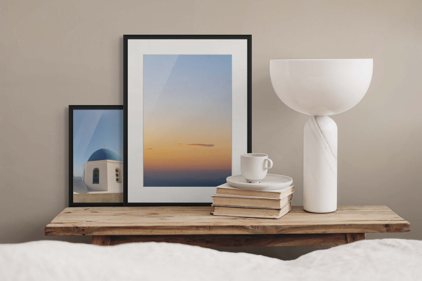 Santorini Sunset by Erica Goldemberg with black frame in a bedroom mockups