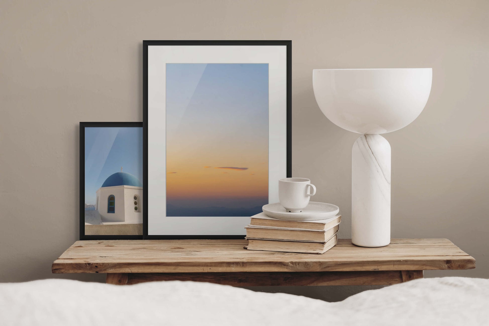 Santorini Sunset by Erica Goldemberg with black frame in a bedroom mockups