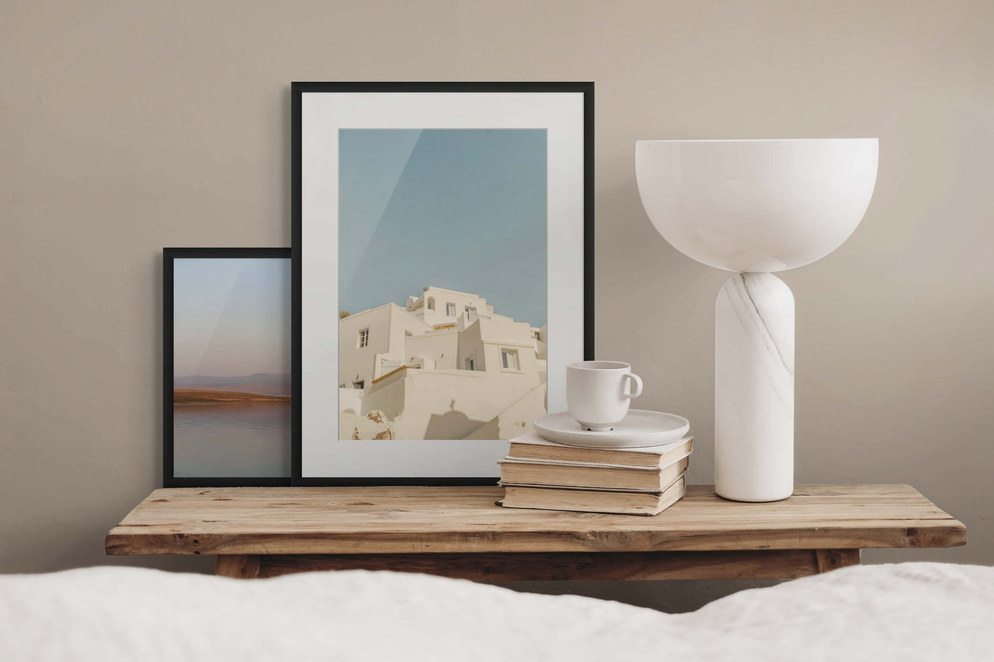 Santorini buildings by Erica Goldemberg with black frame in a bedroom